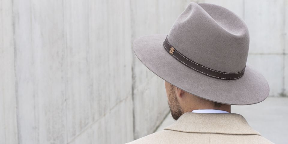 BeWooden - A man wearing brown hat with wooden detail and brown coat.