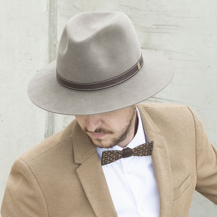 A man wearing the brown Apis hat and a brown jacket