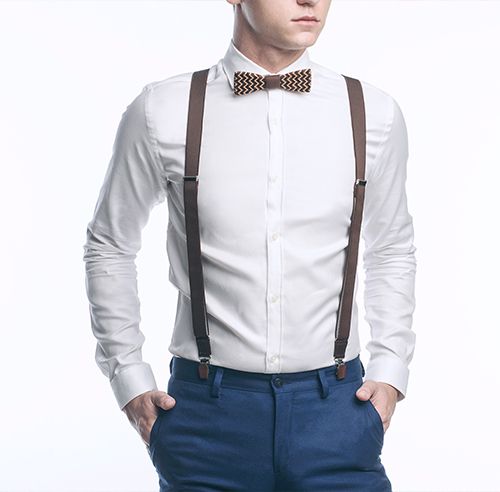 A man wearing a shirt with a wooden bow tie and stylish men's shorts