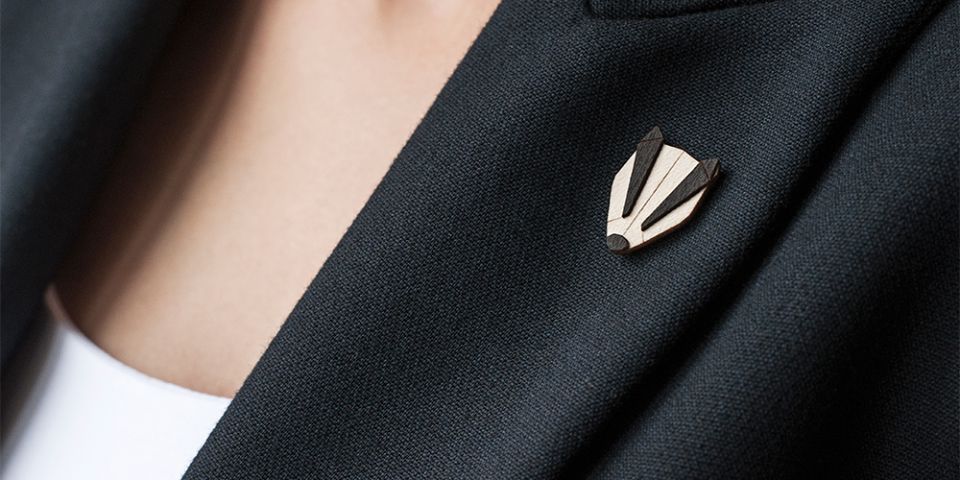 BeWooden - A woman in a jacket with the wooden brooch Badger Brooch