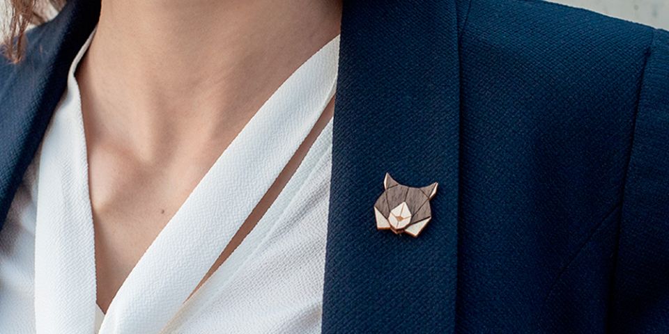 BeWooden - A woman in a jacket with the wooden brooch Lynx Brooch