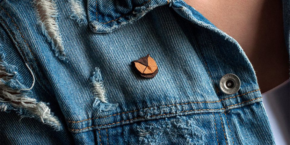 A woman in jeans jacket with the wooden brooch Owl Brooch