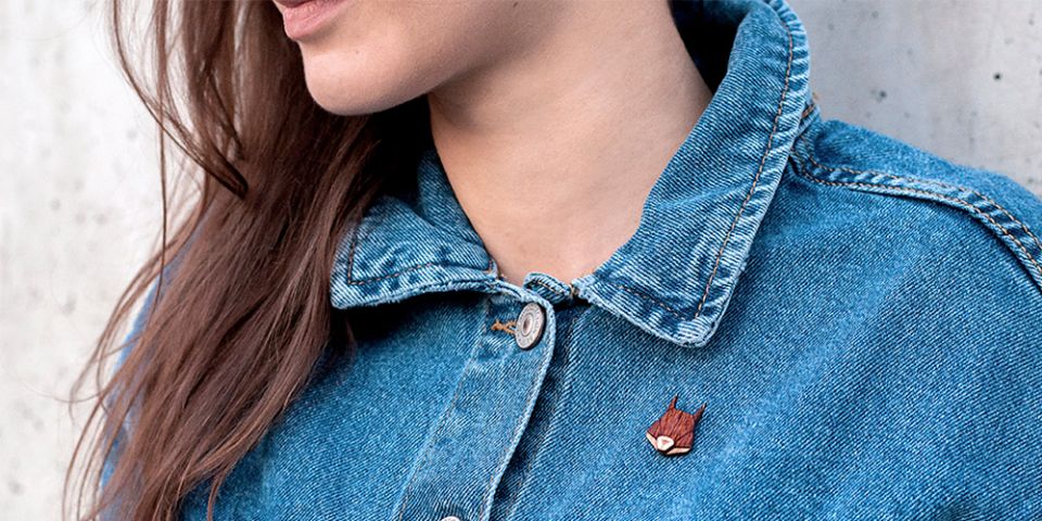 BeWooden - A woman in jeans jacket with the wooden brooch Squirrel Brooch