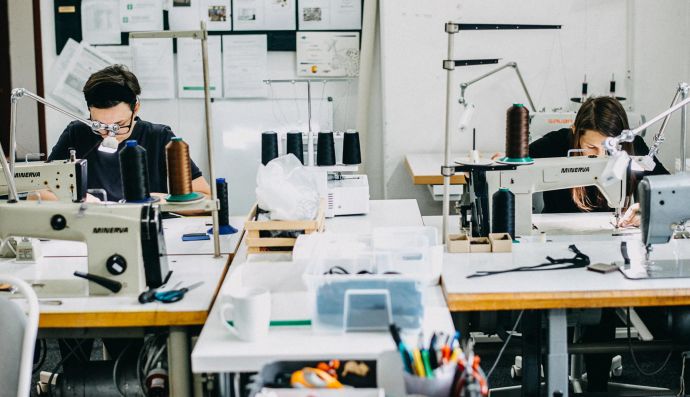 seamstresses sew on machines in the factory