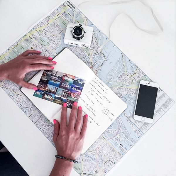 A woman holds a postcard about the BeWooden notebook