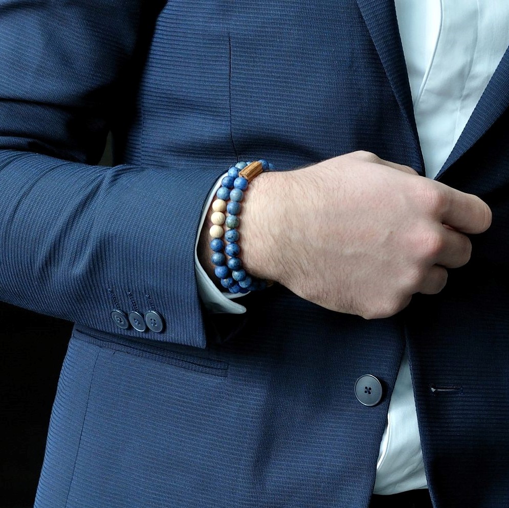 Elegantní muž v modrém saku s náramky BeWooden